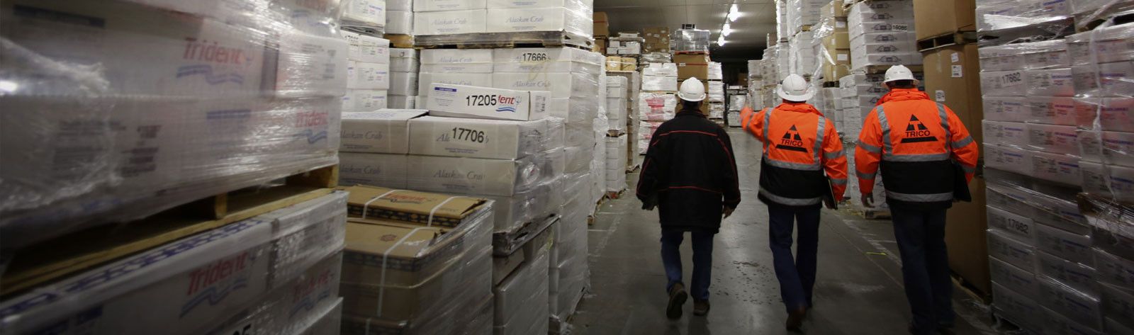 men walking through a cold storage facility