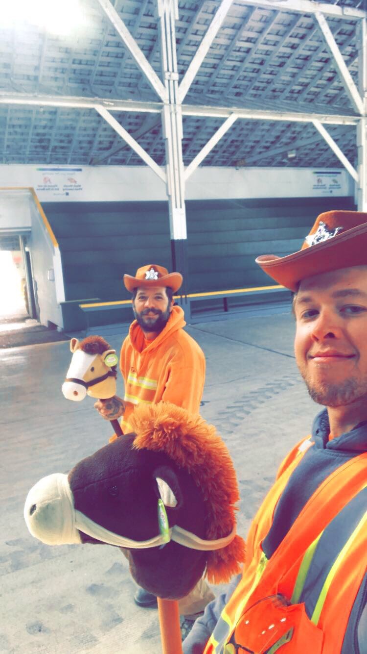 two trico employees wearing cowboy hats and holding toy horses on a stick