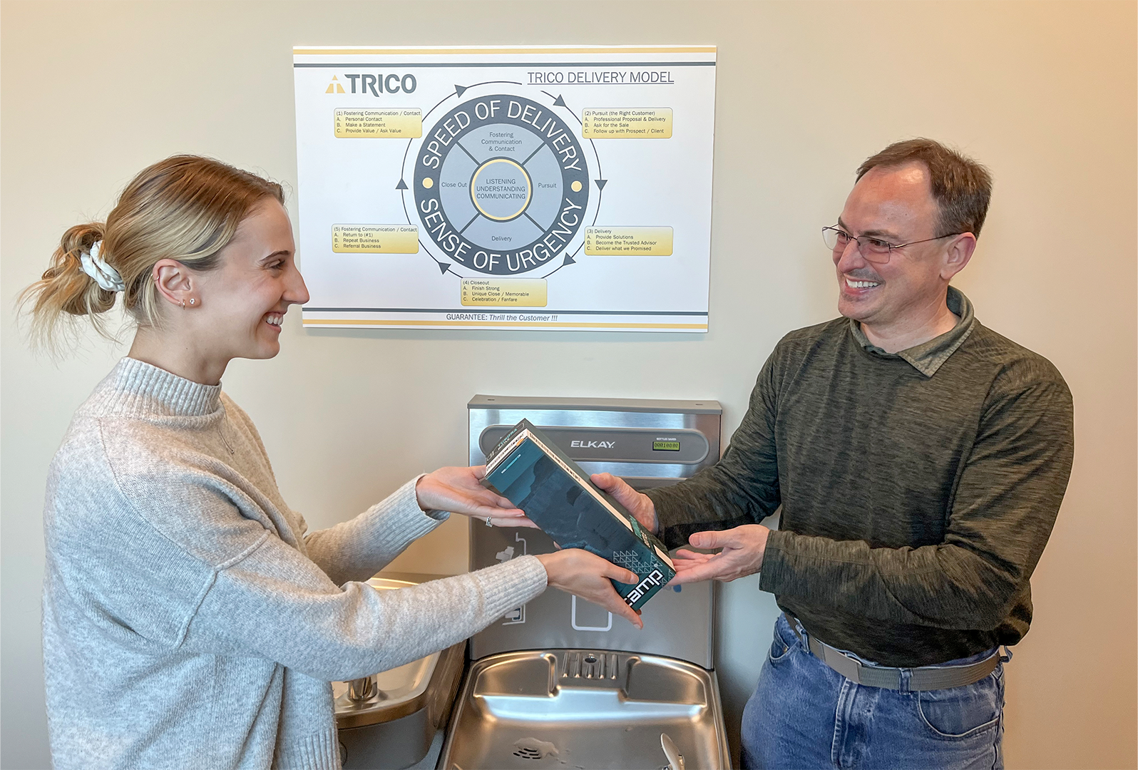 trico employee handing over water bottle for robyn