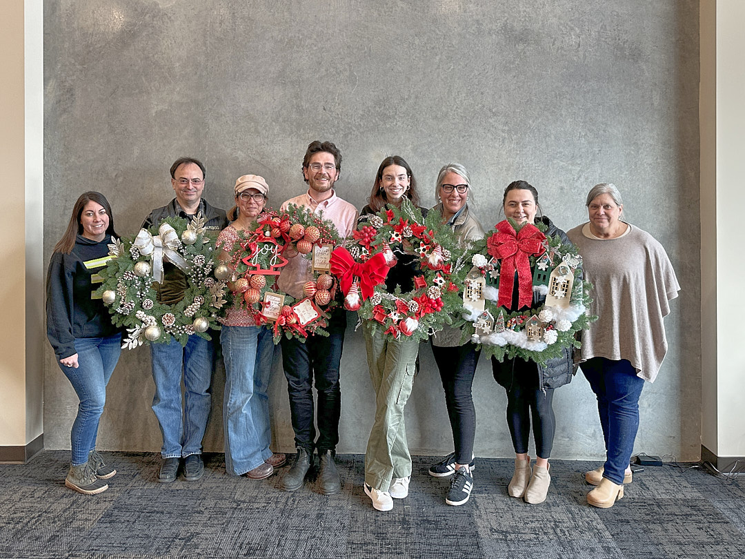 trico employees holding wreaths