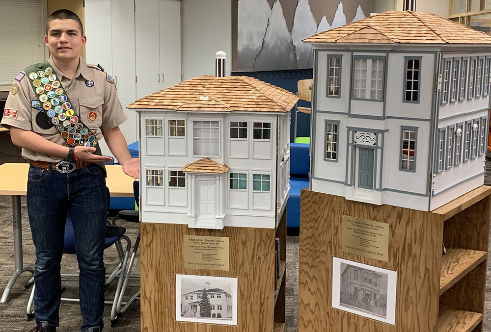 boyscout next to historical house replica